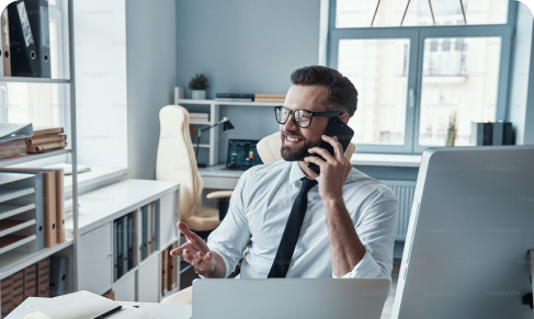 Man on the phone sitting at his desk